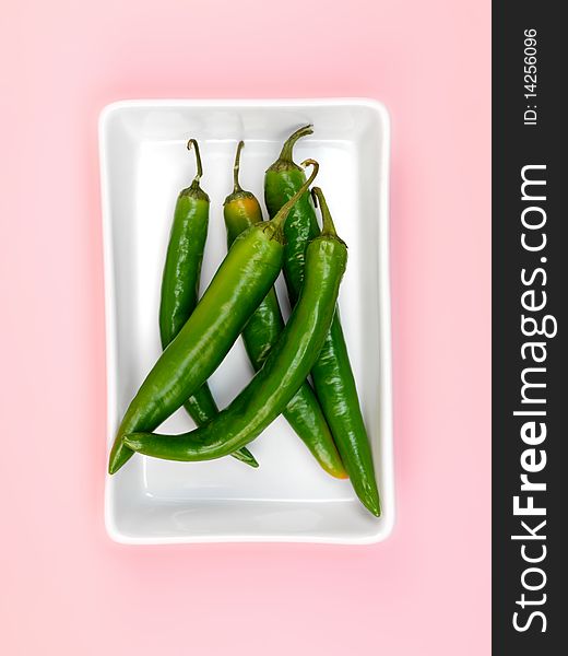 Chilli Peppers isolated on a pink background