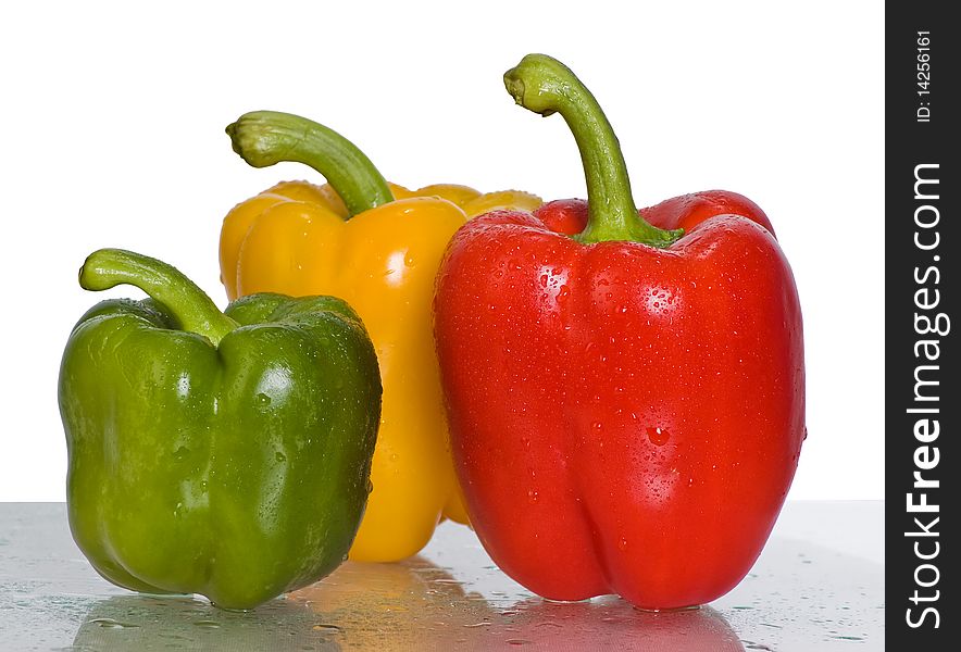 Peppers.Three peppers on a white background. Focus on the red one