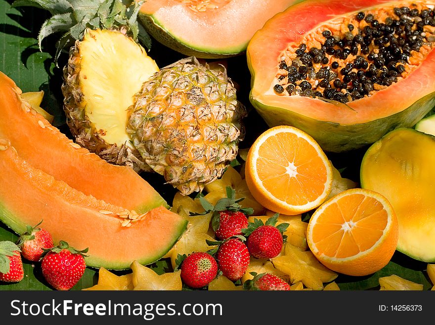 Tropical fruits on green leaves