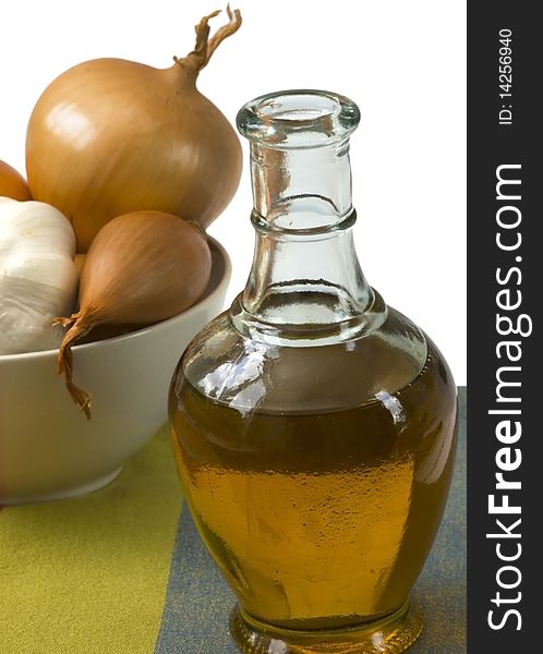 Bottle of olive oil with onion and garlic, isolated