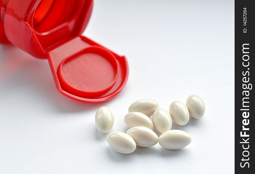 Close up of red medicine bottle with capsules. Close up of red medicine bottle with capsules