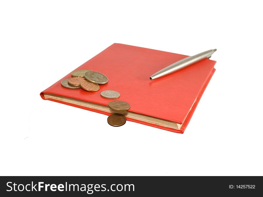 Red notebook and steel pen with coins isolated on white