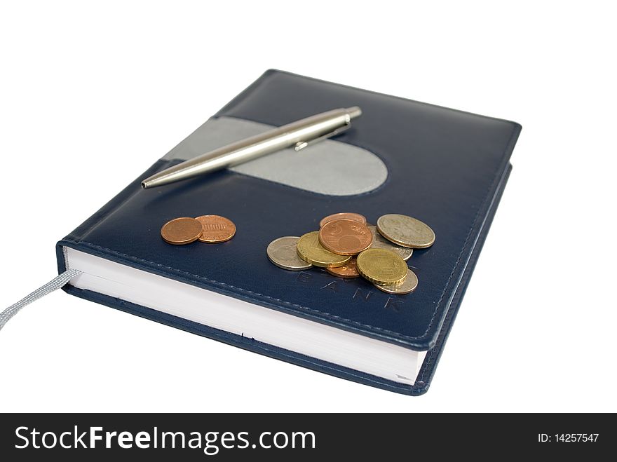 Notebook with coins and pen isolated on white