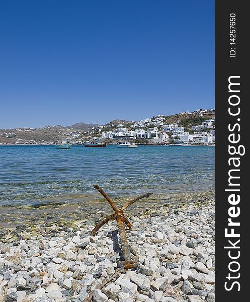 Old anchor on the shore of the bay of Mykonos
