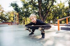 Free Little Boy Trying To Pick Up A Skateboard Stock Photo - 142549740