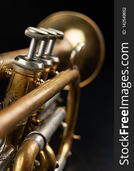 Old Coated Patina Trumpet On A Dark Table. An Inedible Musical Instrument