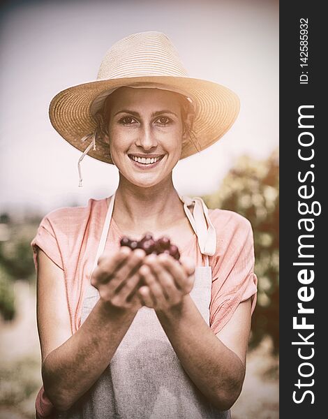 Portrait Of Smiling Farmer Holding Red Grapes