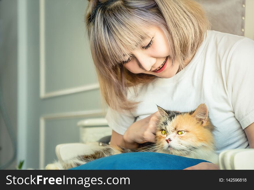 Portrait of Asian female playing with cute cat