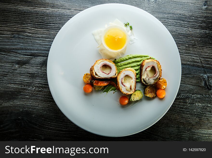 Top View Dissected Chicken Kiev Cutlets With Grilled Vegetables And Sauce