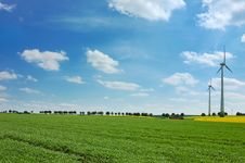 Wind Turbines Among Rapeseed Field And Meadows Stock Photo Wind Turbines Among Rapeseed Field And Meadows Stock Photo
