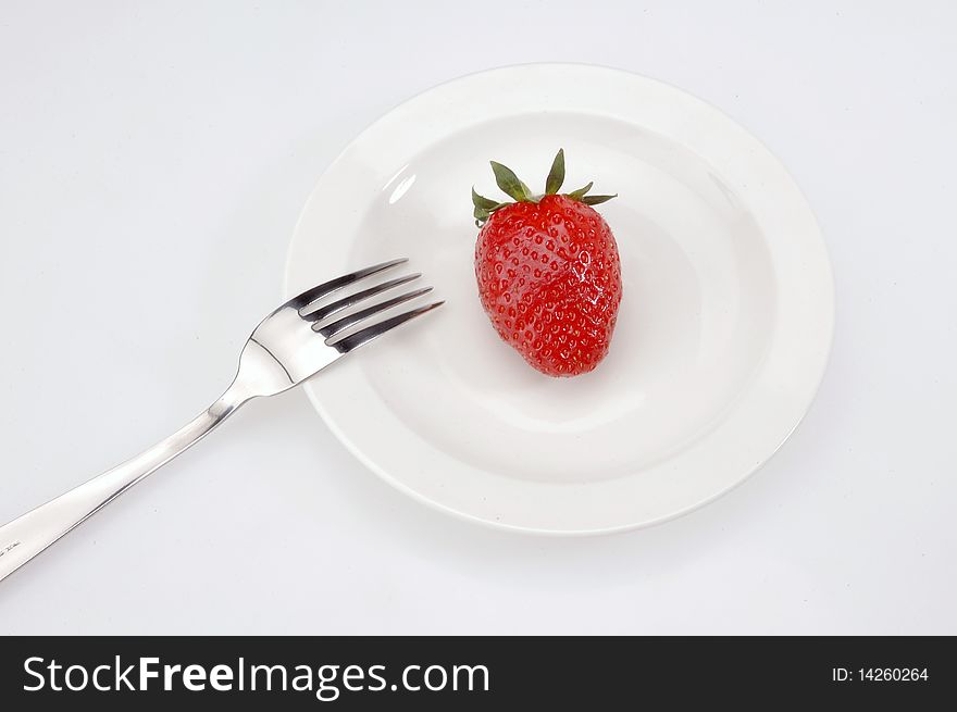 Strawberry and forks on the white Plates