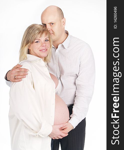 Pregnant woman poses with her husband . Not a young pair. Pregnant woman poses with her husband . Not a young pair