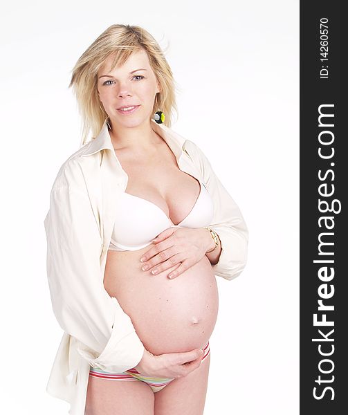 Portrait of a pretty woman holding pregnant belly , smiling over white. Portrait of a pretty woman holding pregnant belly , smiling over white