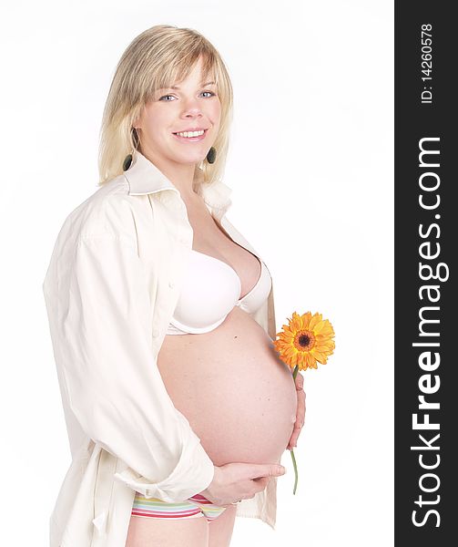 Portrait of a pretty woman holding pregnant belly , smiling over white. Portrait of a pretty woman holding pregnant belly , smiling over white