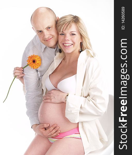Pregnant woman poses with her husband. Not a young pair. Pregnant woman poses with her husband. Not a young pair