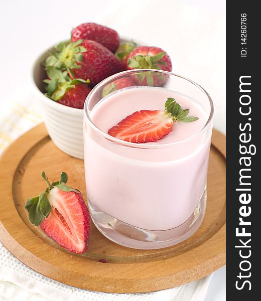 Strawberry yoghurt with  fresh strawberry. On  background a bowl with  strawberry
