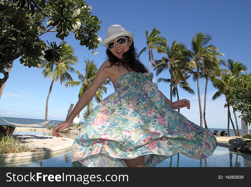 An asian girl at a tropical resort