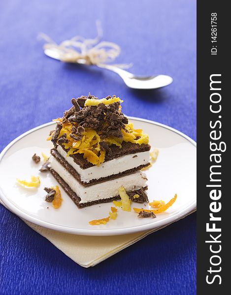 Chocolate cake with orange and bizet on plate