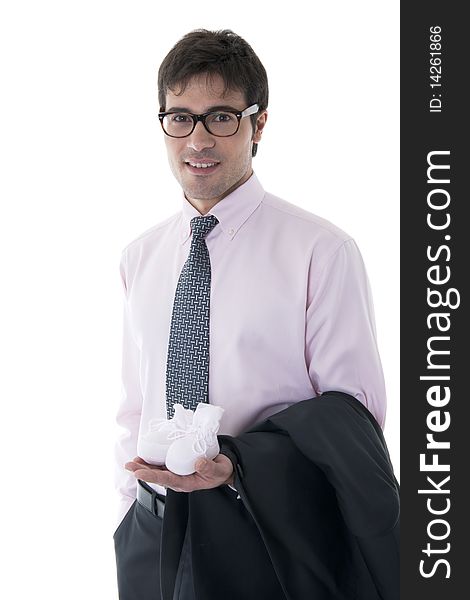 Man holding baby shoe and business jacket. Concept: modern man, multi-tasking