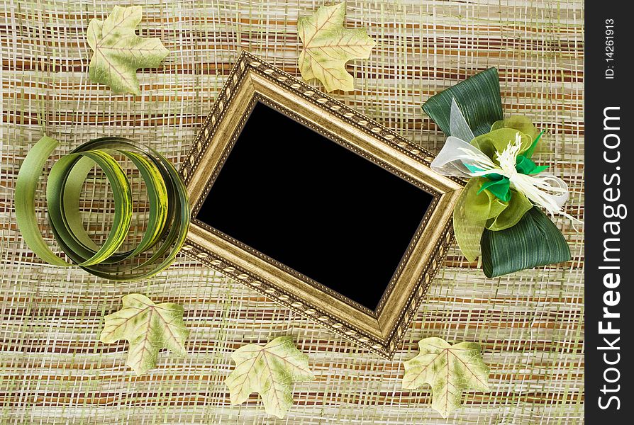 Creative background made of vintage blank frame and decorative textile leaves