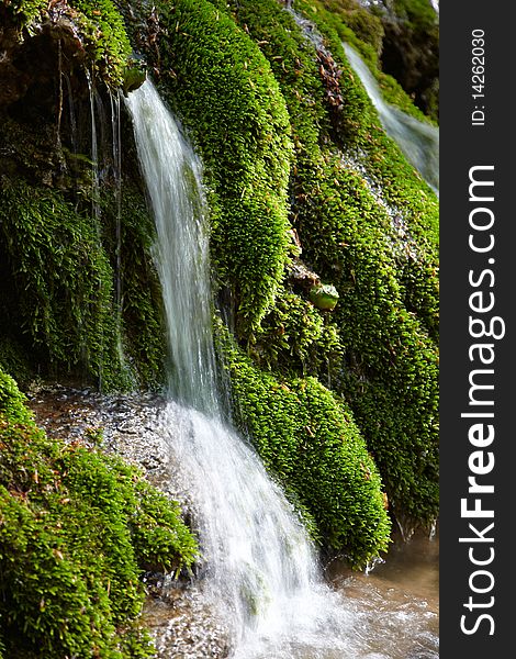 Waterfall betwiin stones on a mountains river