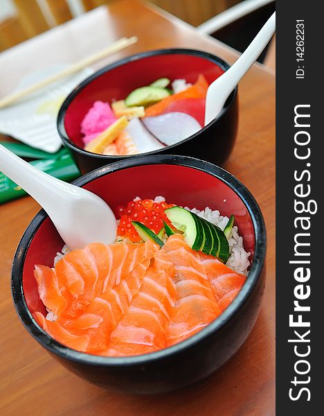 Bowl of Japanese salmon don (sushi rice) topped with salmon roe, and a bowl of mixed sashimi don. Bowl of Japanese salmon don (sushi rice) topped with salmon roe, and a bowl of mixed sashimi don