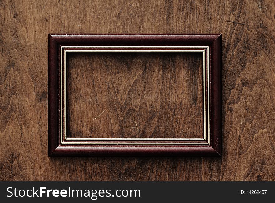 Blank frame on old wooden background