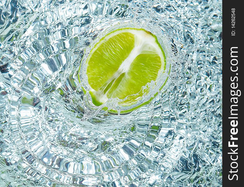 Fresh lime in water with a splash