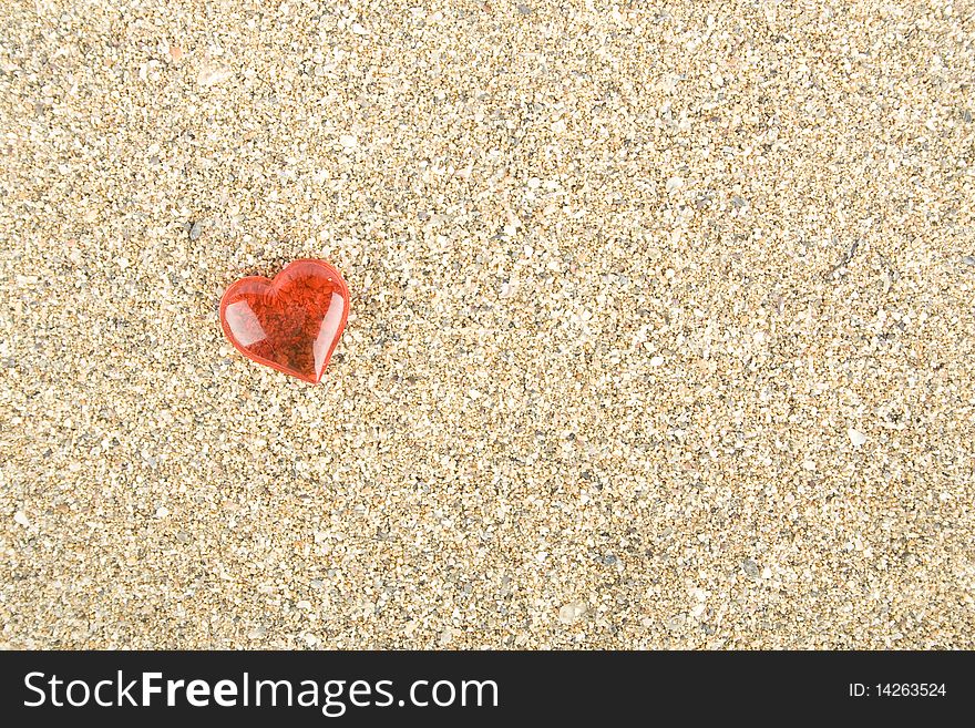 Red heart on the sand. Background. Red heart on the sand. Background