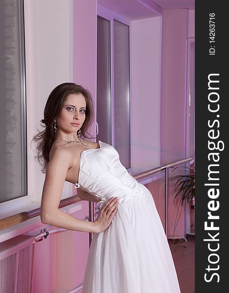 Girl in white wedding dress in dance studio. Girl in white wedding dress in dance studio
