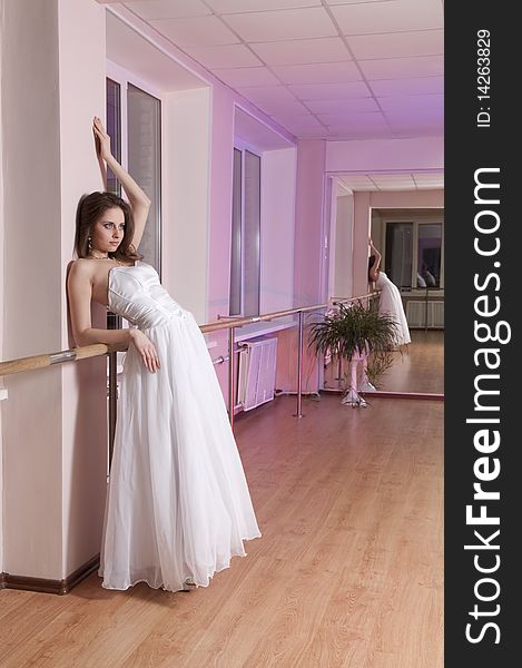 Girl in white wedding dress in dance studio. Girl in white wedding dress in dance studio