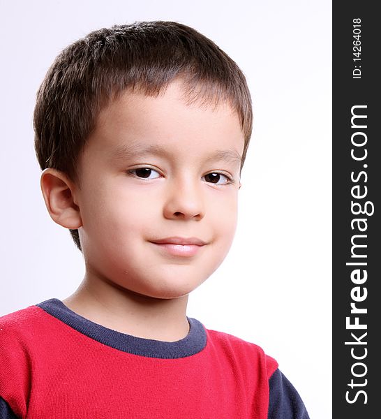 Smiling boy looking at camera over white background. Smiling boy looking at camera over white background