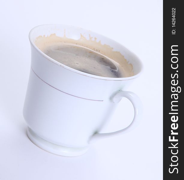 White cup with coffee over white background