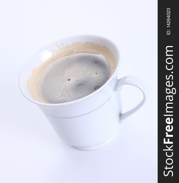 White cup with coffee over white background. White cup with coffee over white background