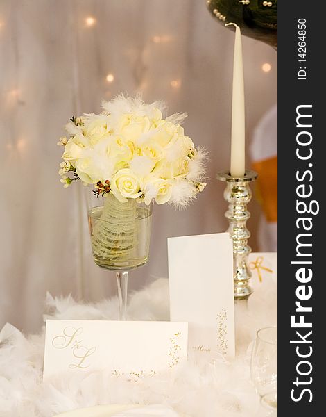 Yellow flowers and silver candle on the table. Yellow flowers and silver candle on the table