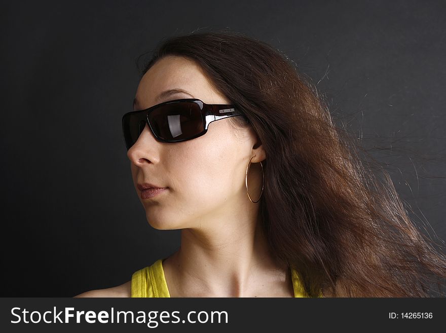 A portrait of a woman in sun glasses with dark hair