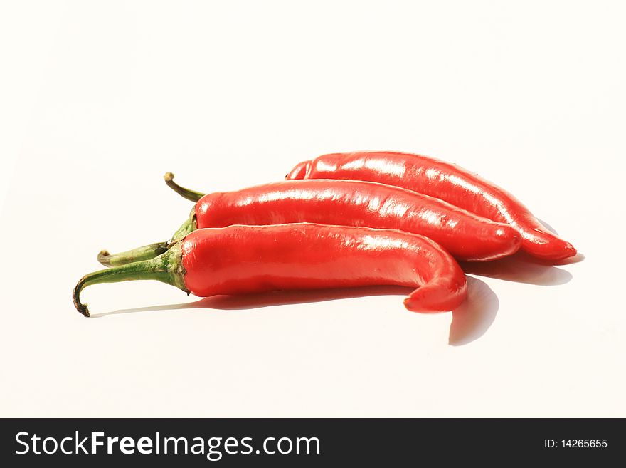 Red chili peppers on a white background, Thailand. Red chili peppers on a white background, Thailand.