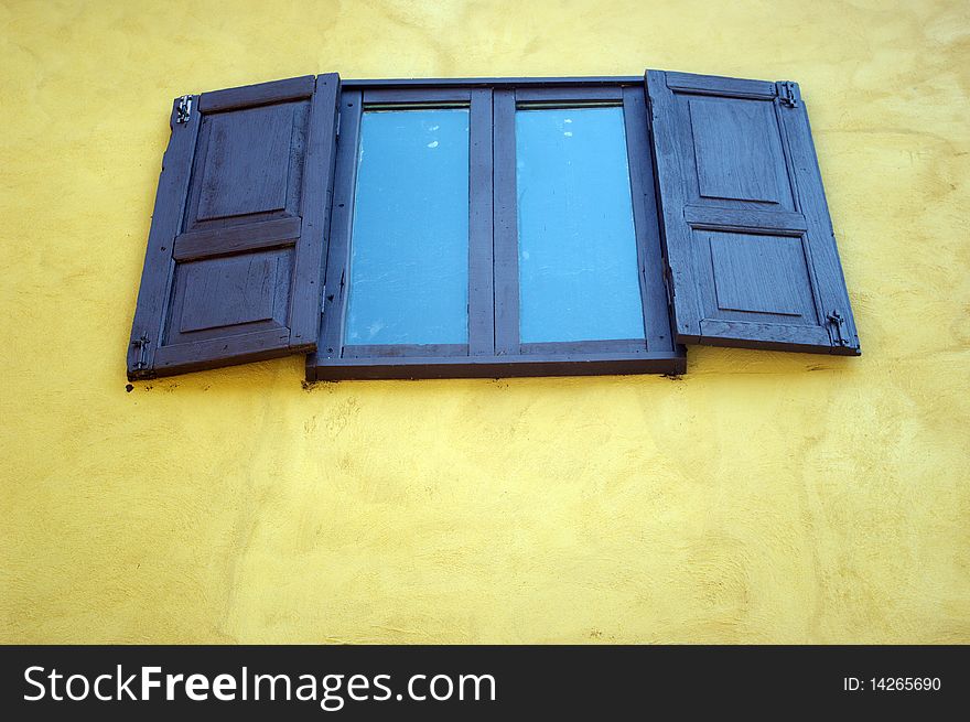 Wood door with a yellow building. Wood door with a yellow building.