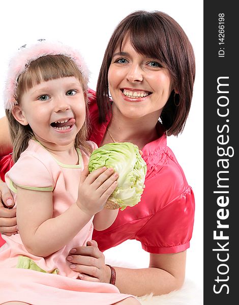 Happy family. Beautiful mother and her little daughter wants to eat cabbage. Series. Happy family. Beautiful mother and her little daughter wants to eat cabbage. Series