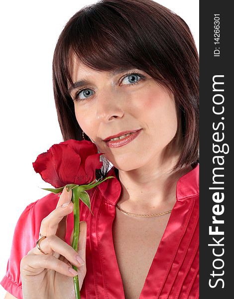 Beautiful woman in love holding a red rose isolated over a white background. Beautiful woman in love holding a red rose isolated over a white background