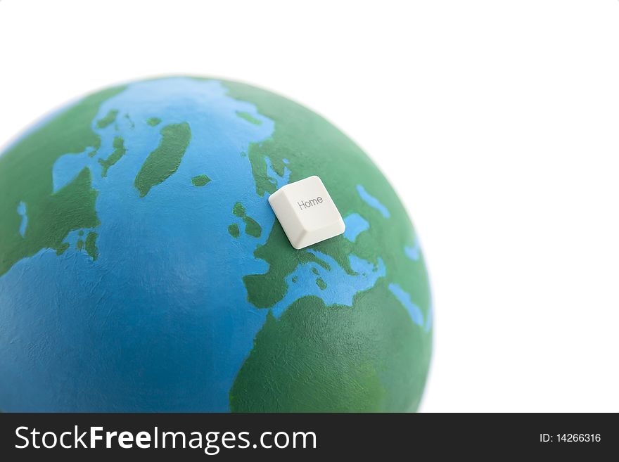 Home computer key on an earth globe isolated on white