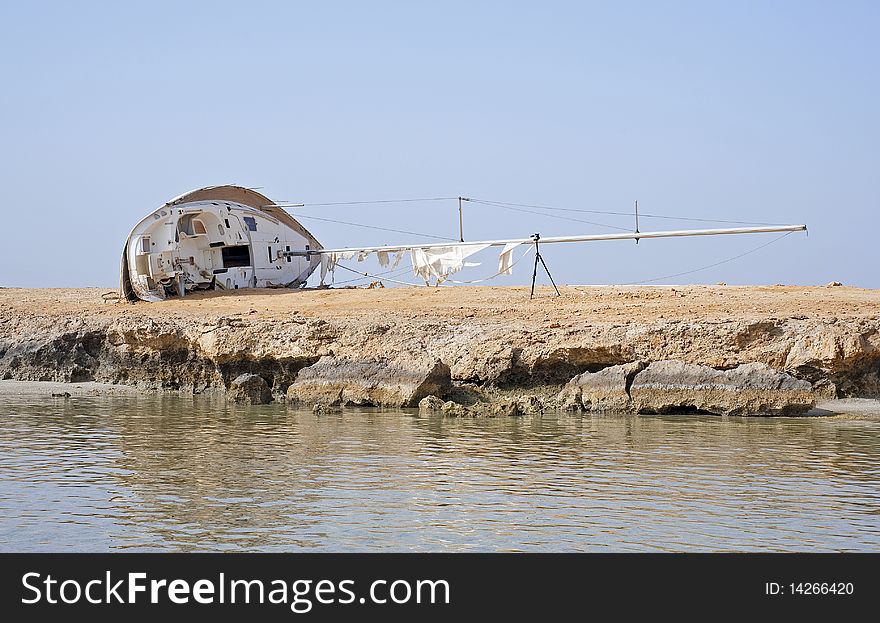 Wreckage Of A Sailing Yacht On The Shore