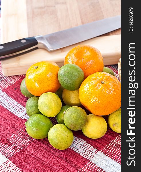 Citrus fruits in front of cutting board. Citrus fruits in front of cutting board