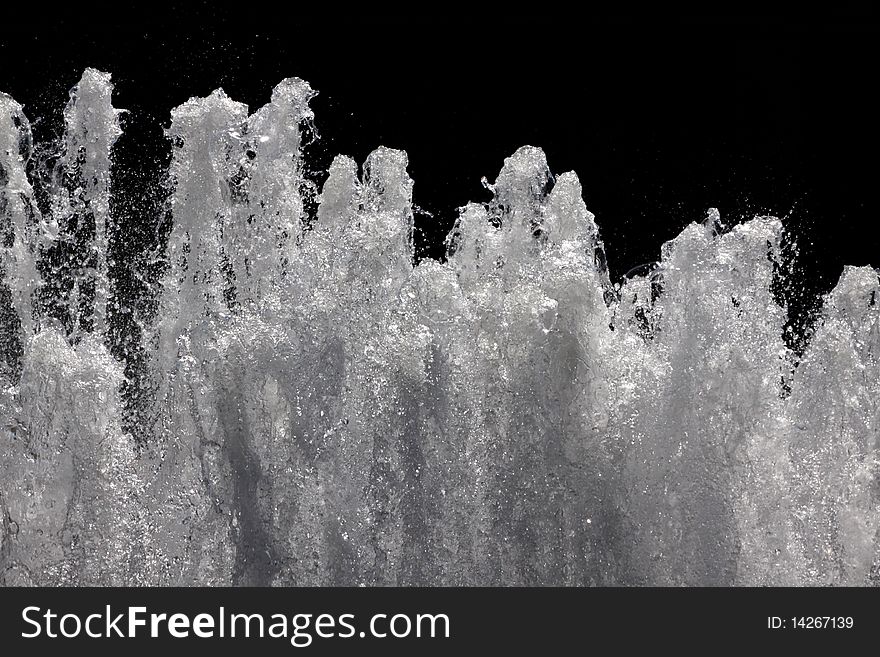 Fountain in front of a black marble construction