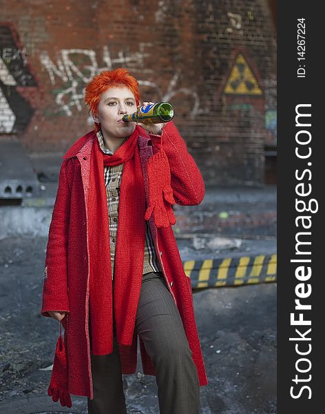 Red-haired woman is drinking beer