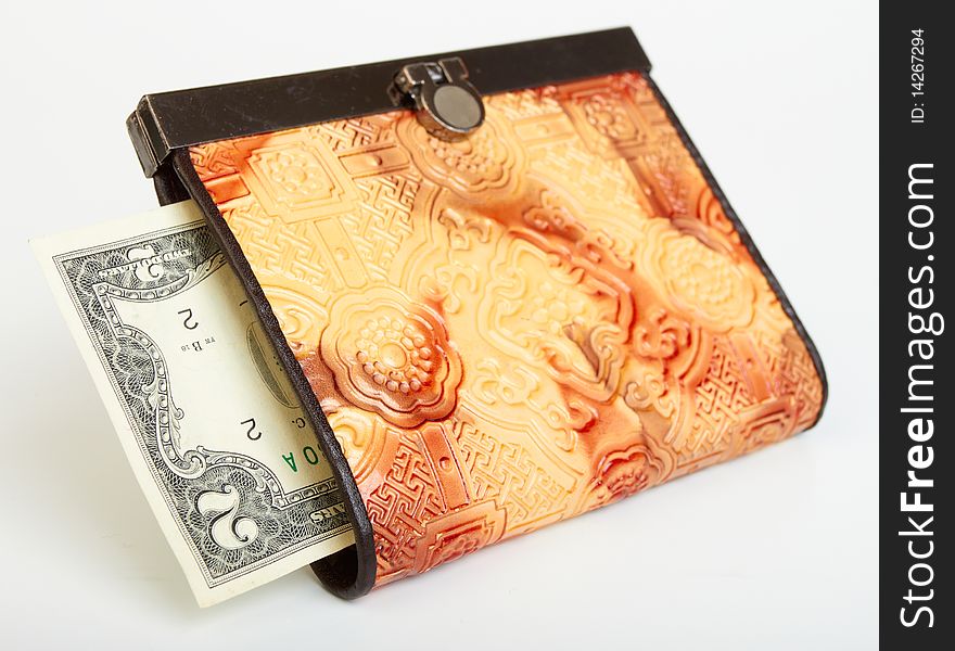 Two dollar bill in purse on white background