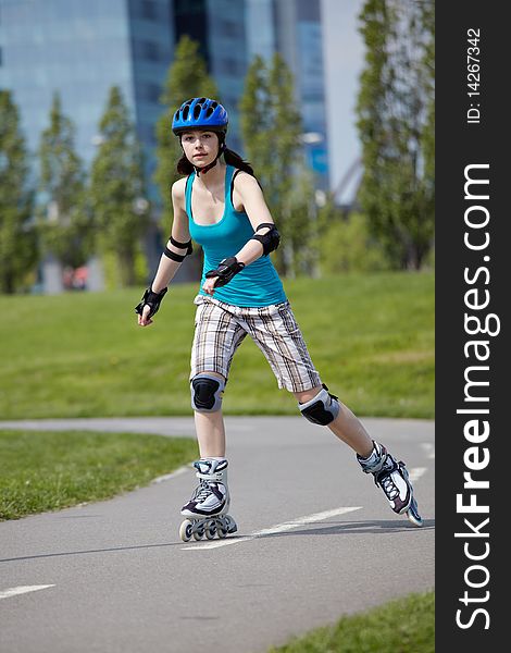 Young girl is rollerblading in the park. Young girl is rollerblading in the park.