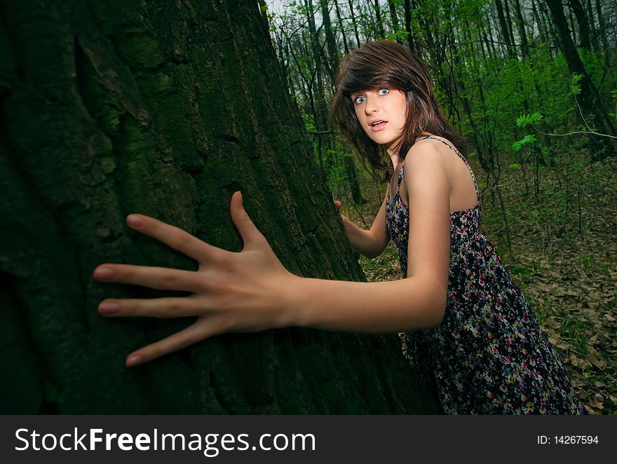 Young pretty frightened girl in the forest. Young pretty frightened girl in the forest