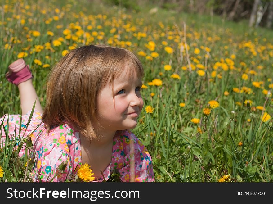 Little girl lie among yellow dandelions. Little girl lie among yellow dandelions