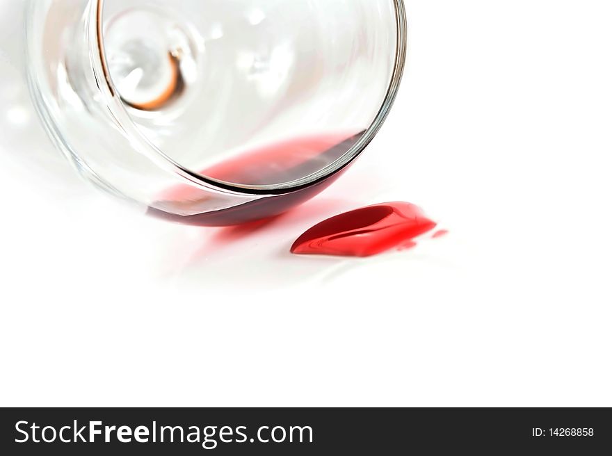 Red wine spilling from glass